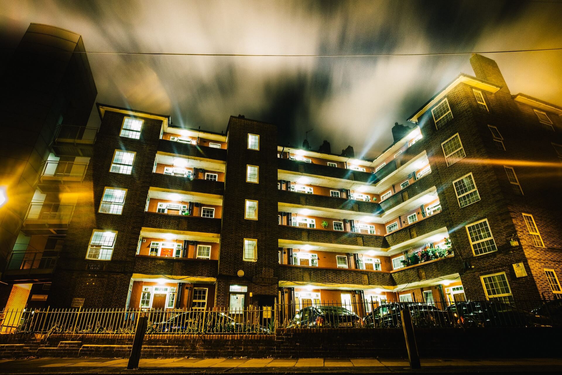 A block of council flats lit up at night