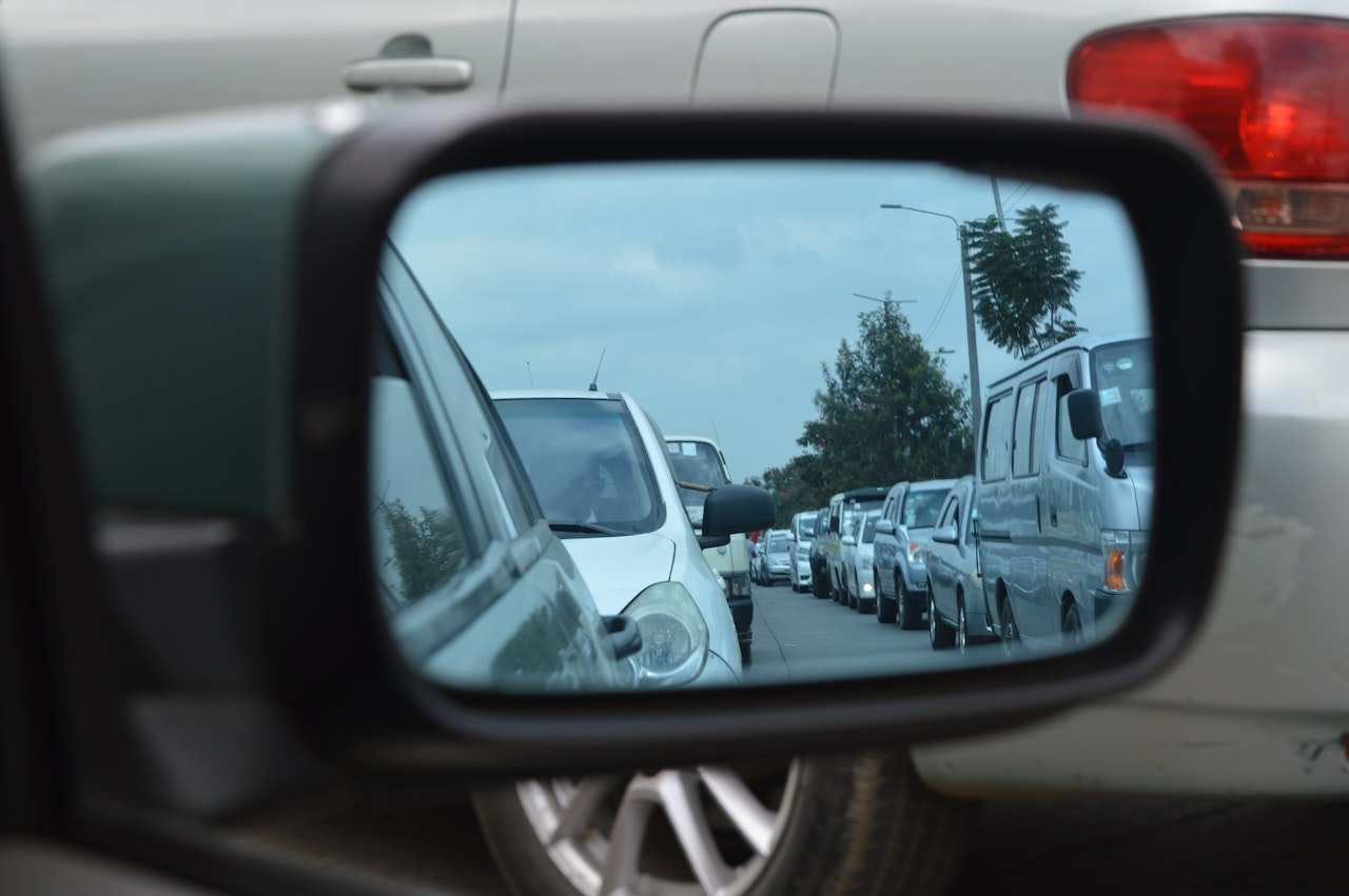 image of rear view mirror looking at traffic jam