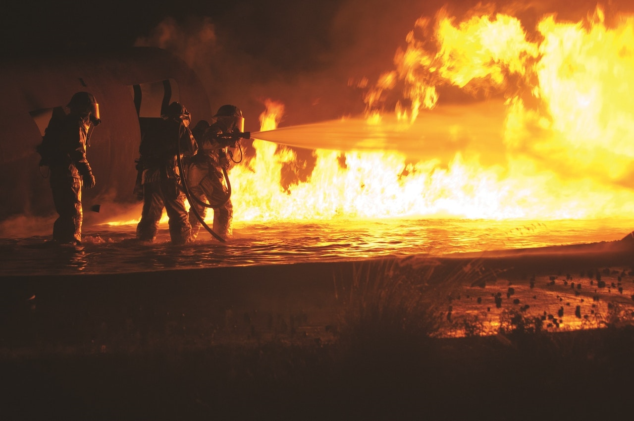 firefighters fighting a flame at night