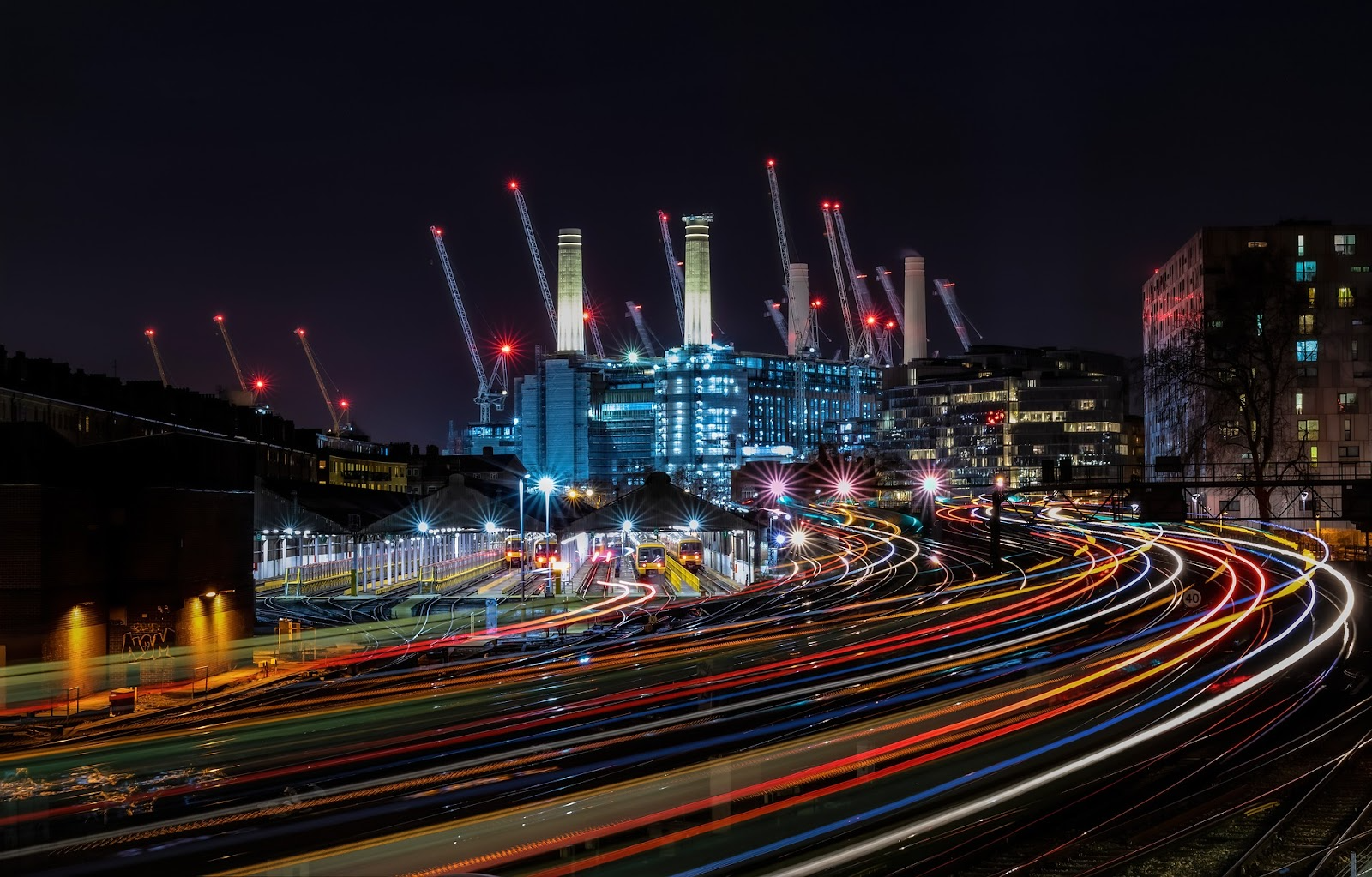 Luminous photo of Battersea Power Station in the distance at night