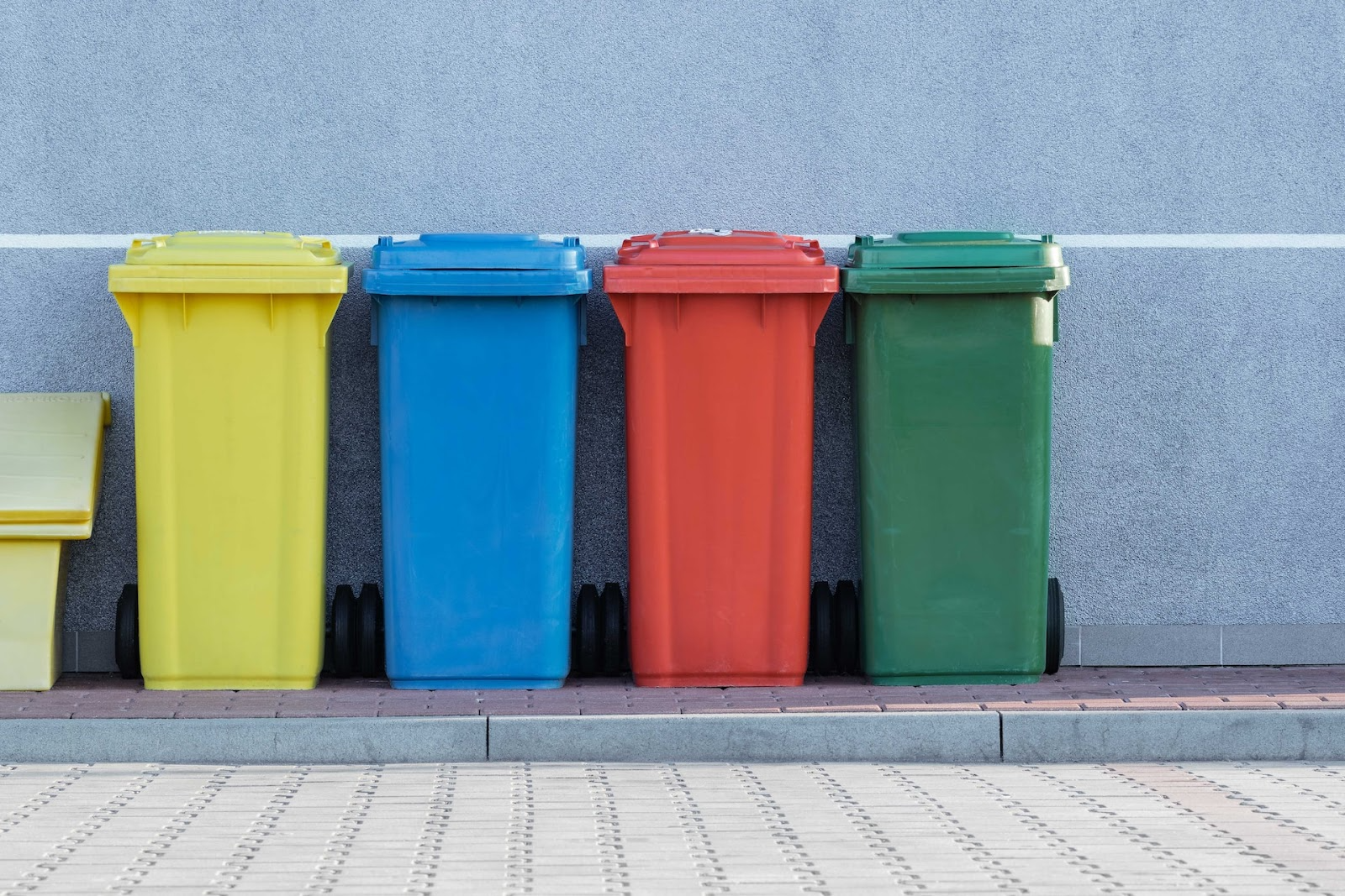 four different coloured bins