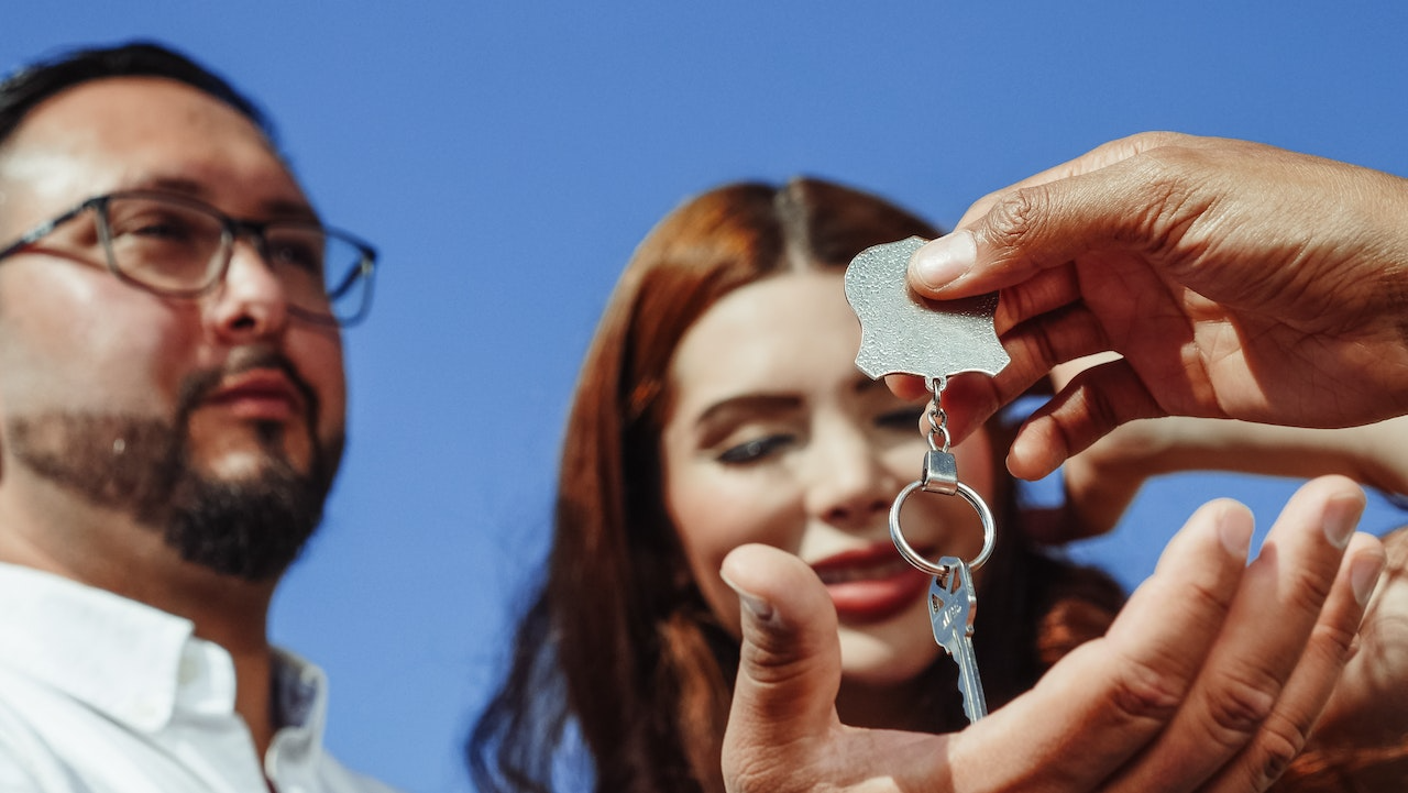 A couple receiving keys for their property