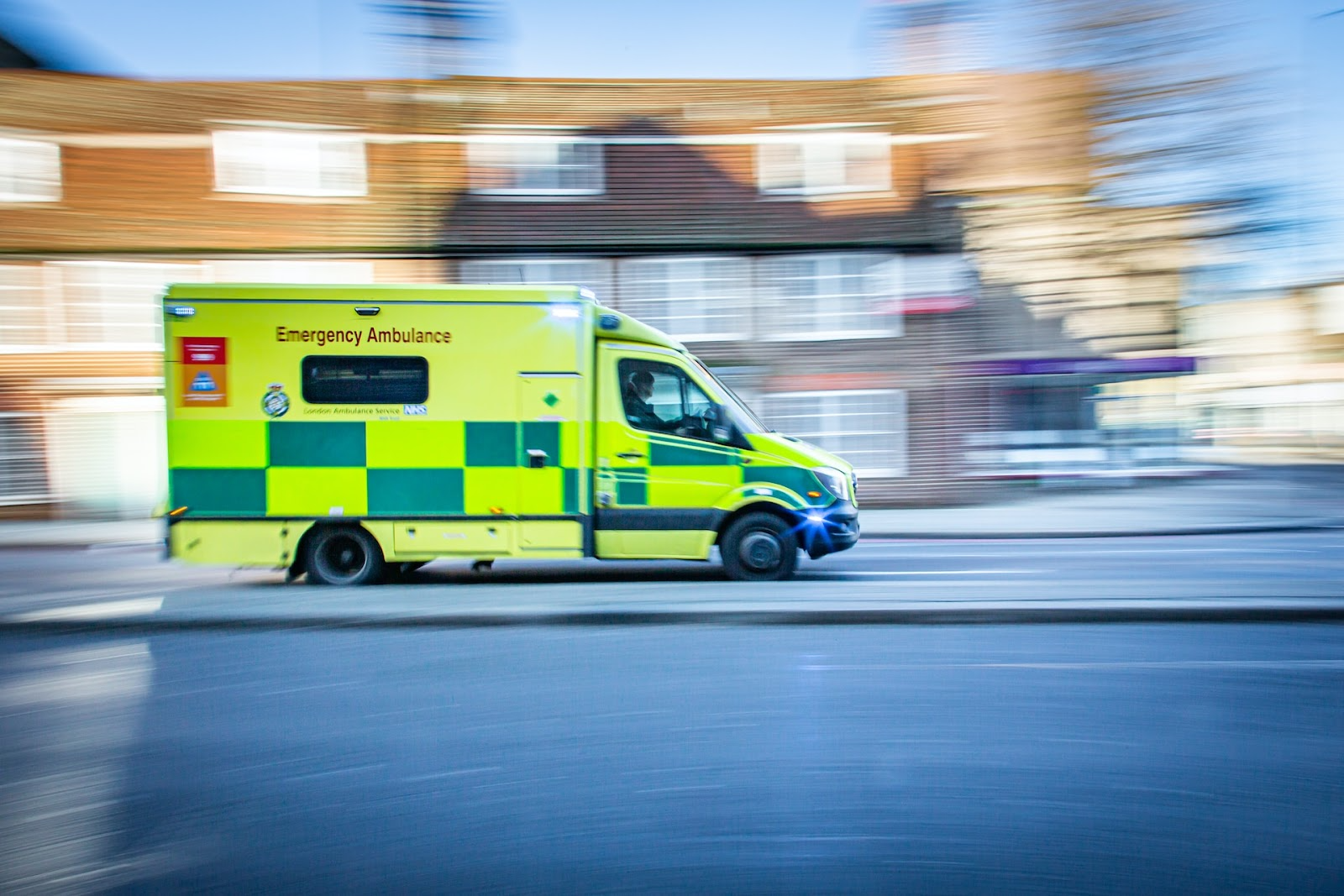 An ambulance rushing through a street