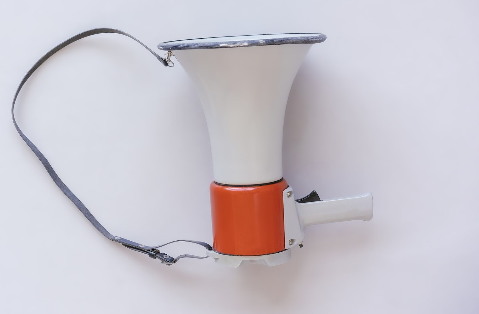 A red and white megaphone sat on a white table