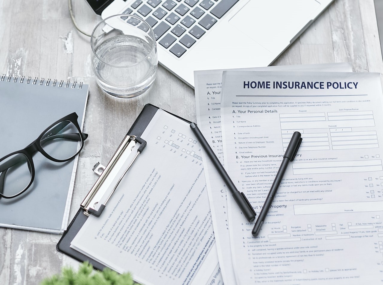 A home insurance policy document on a desk