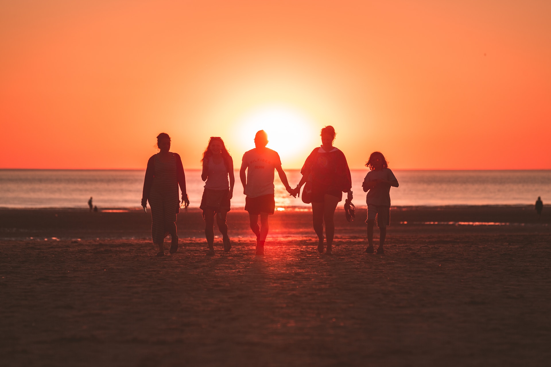 A family on a beach at sunset