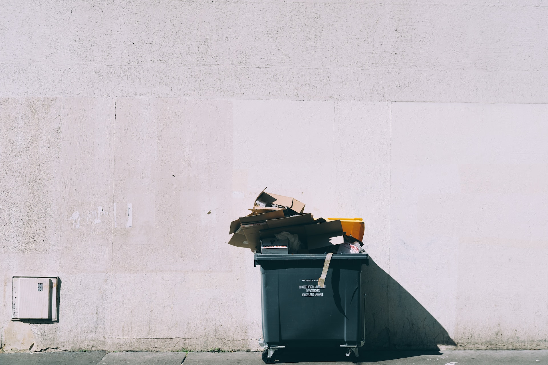 An overloaded recycling bin