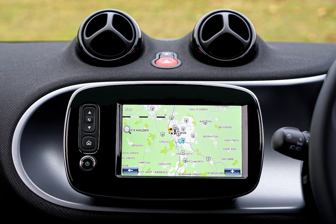 A car dashboard with a sat nav attached