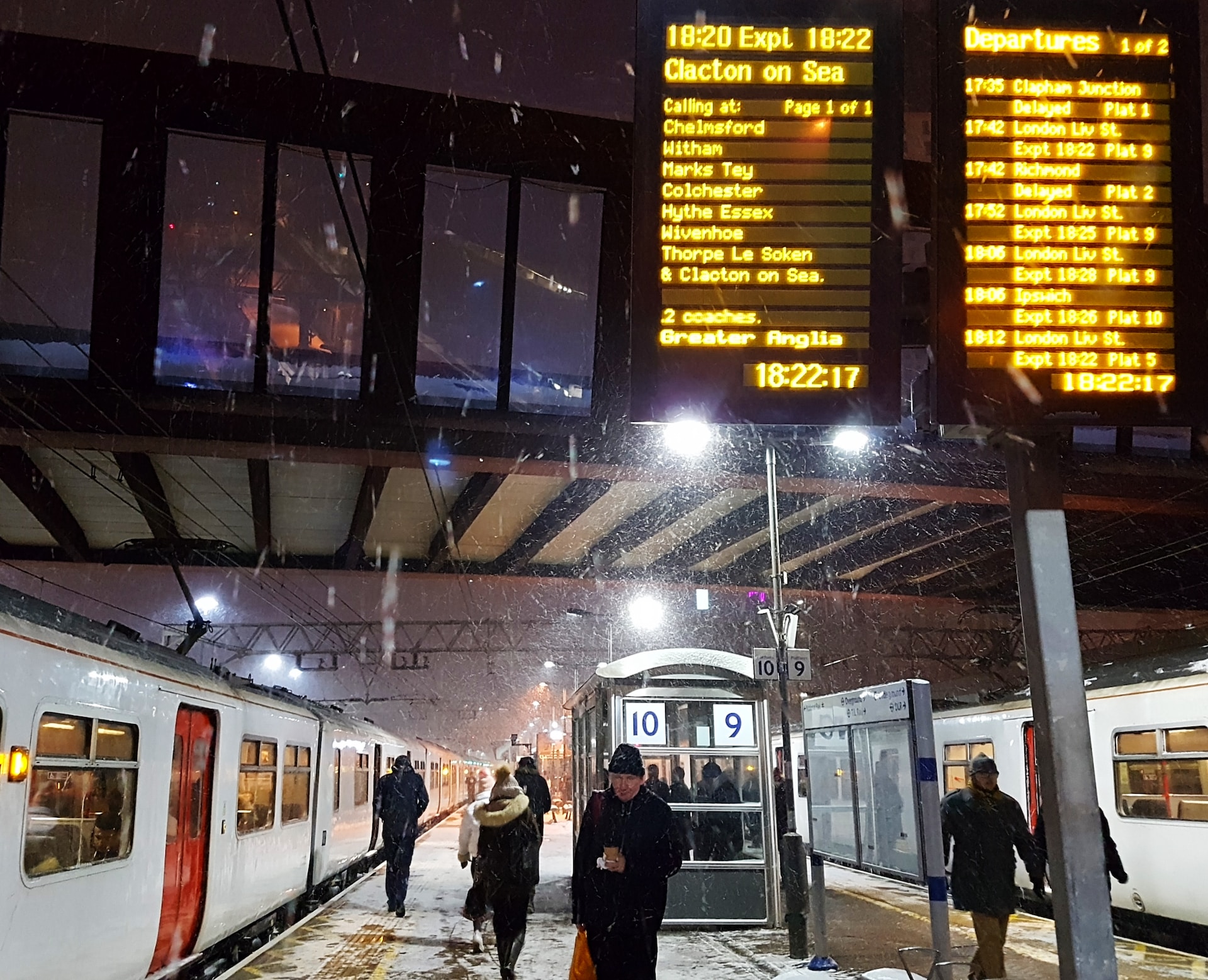 People waiting on a snowy train platform