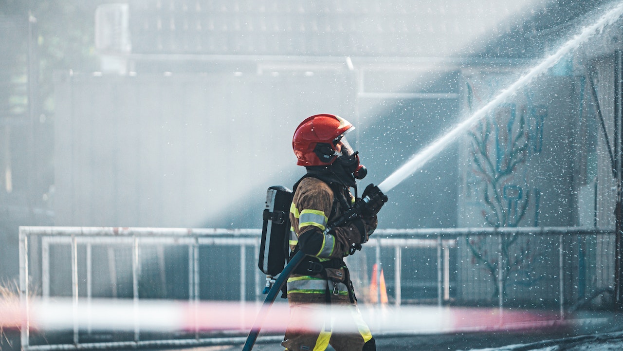 A firefighter using a hose