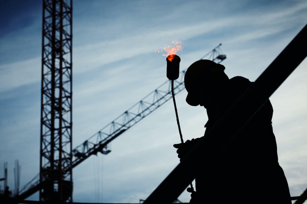 man holding a flamethrower on a worksite