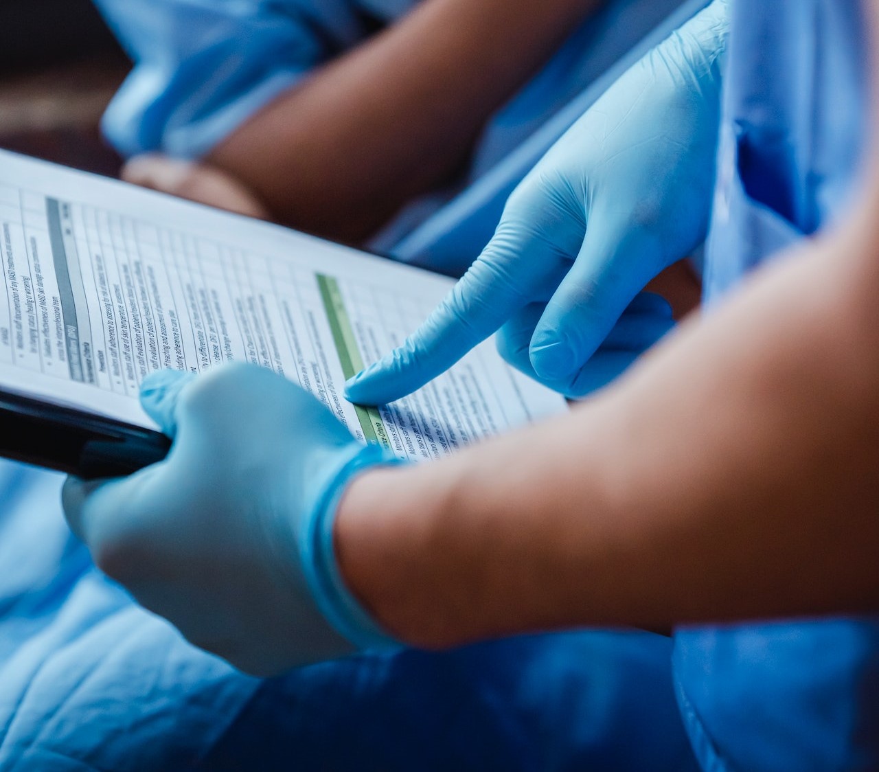 Hospital workers looking over medical records