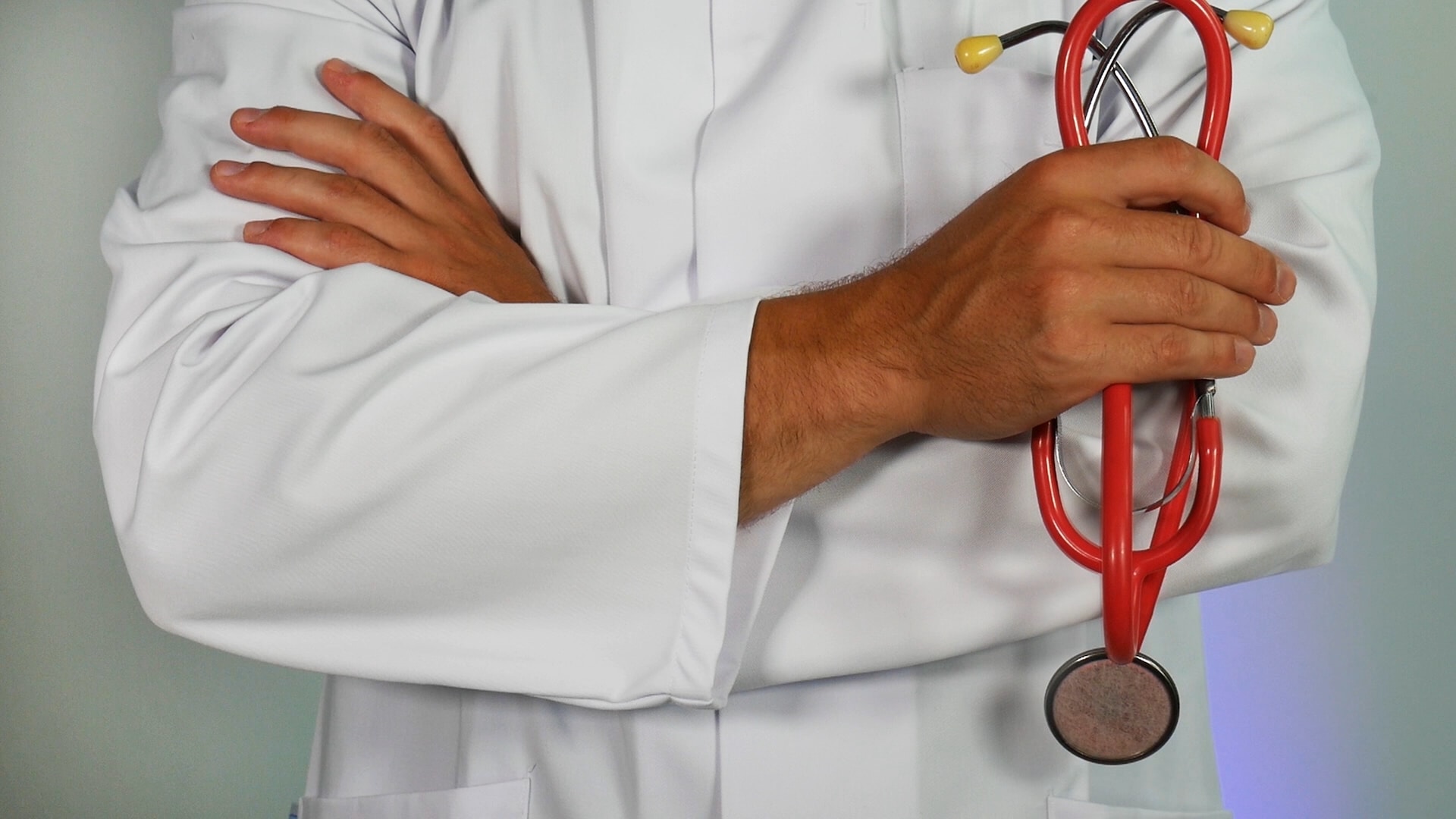 a doctor holding a red stethoscope