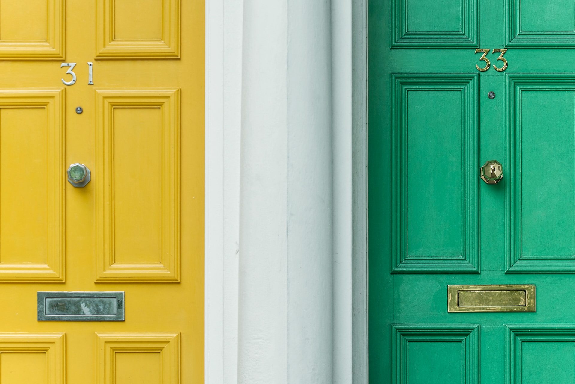 A yellow and green front door side by side