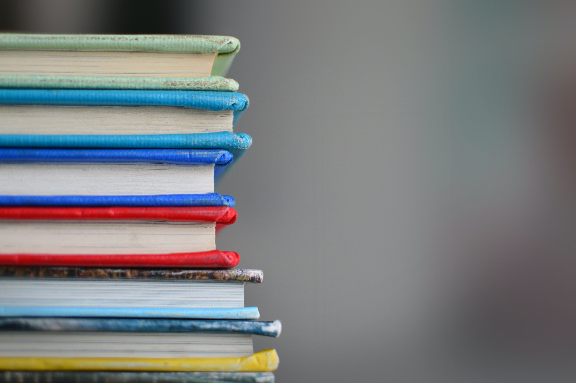 A stack of different coloured books