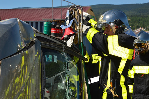 Firefighter cutting through a wrecked car