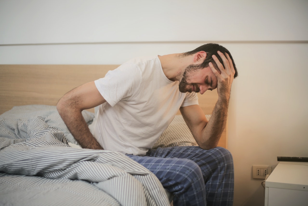 A man in bed feeling ill