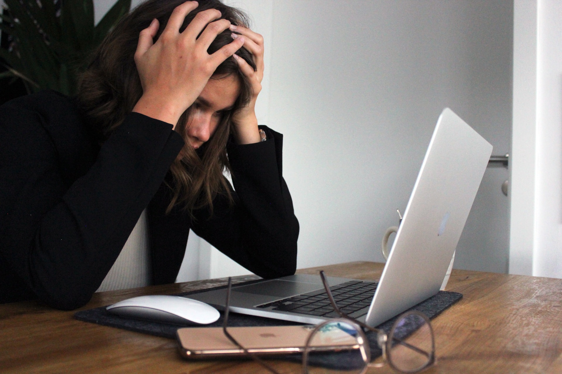 A woman looking stressed at their desk