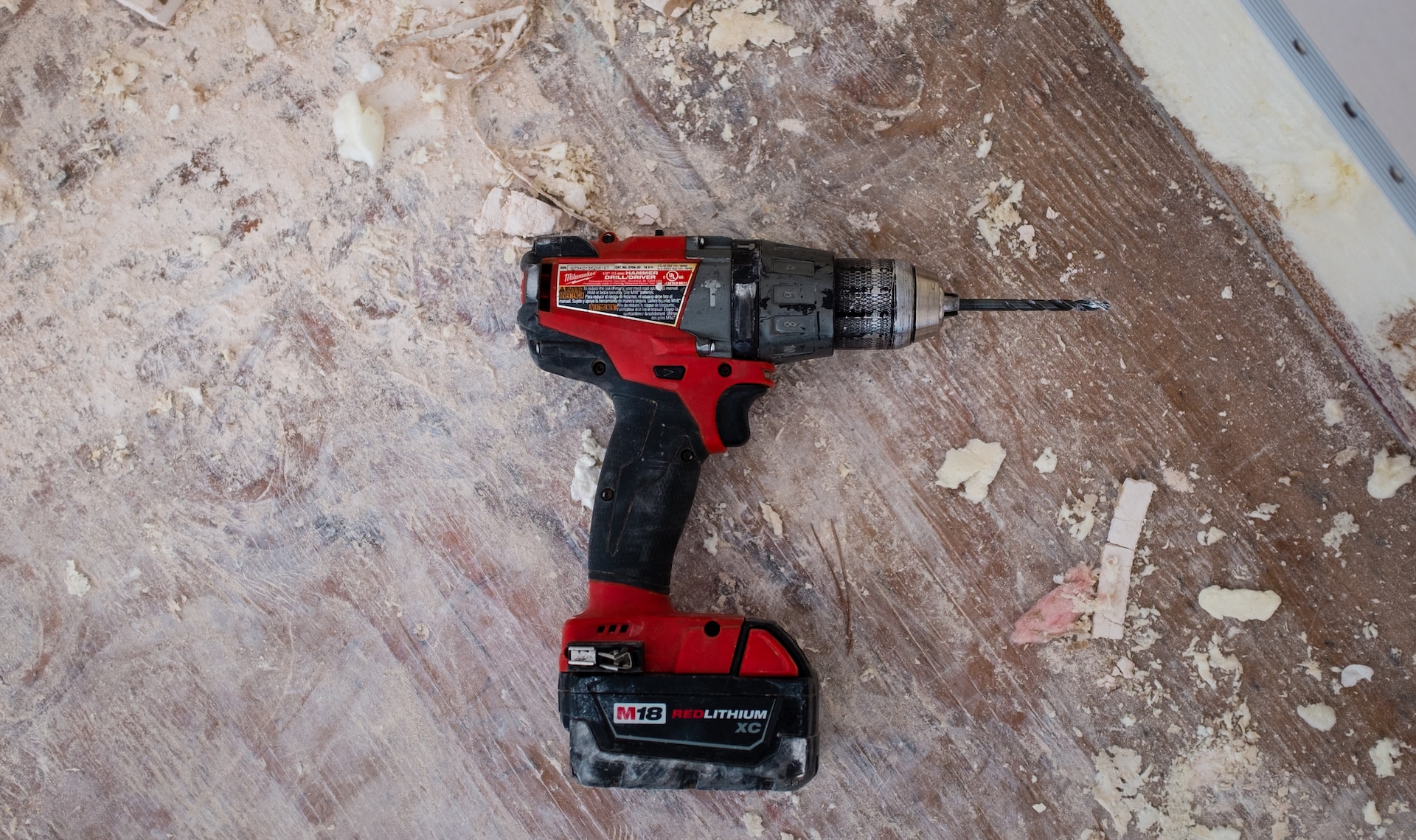 A red electric drill on the ground