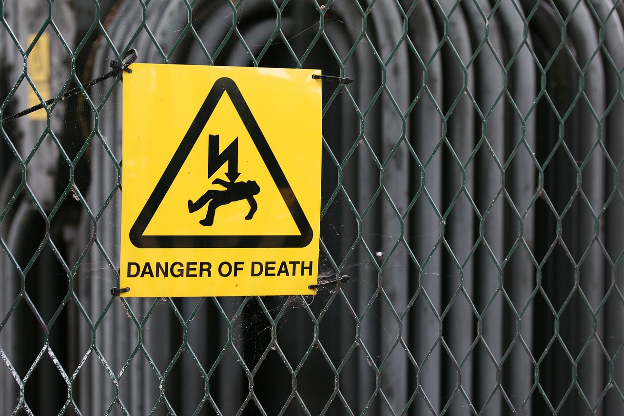 'Danger of death' warning sign on a metal fence