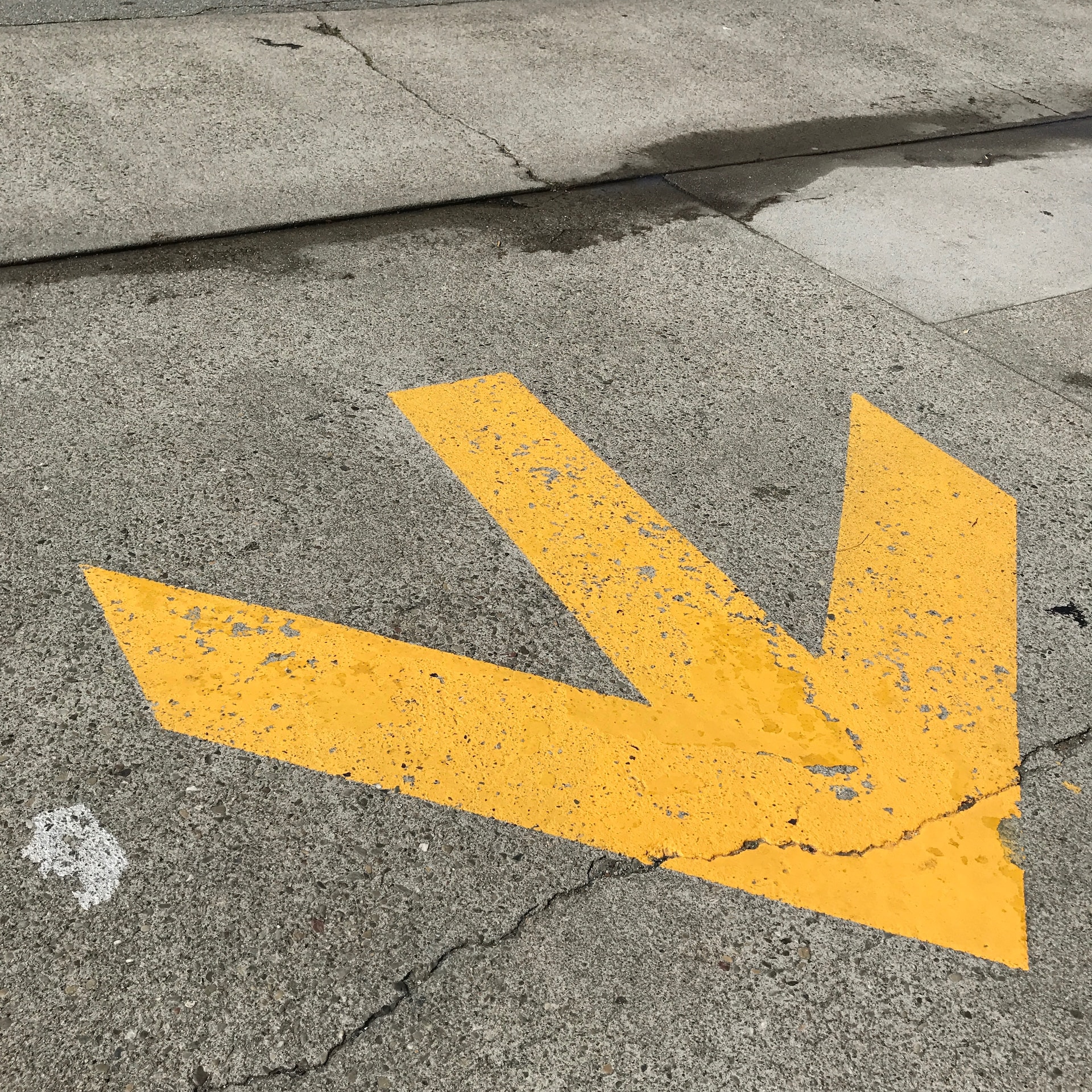 A yellow arrow on a road