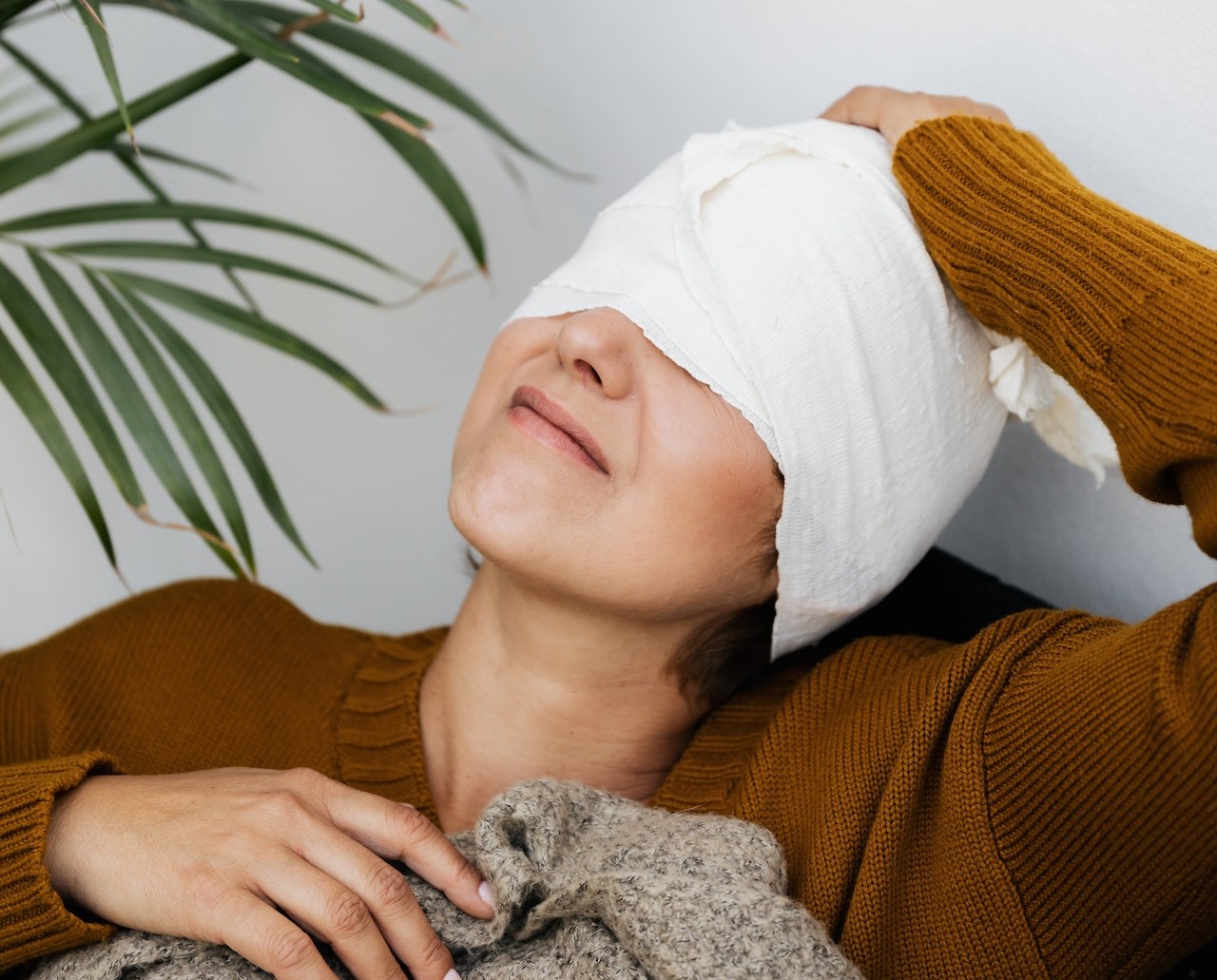 Same woman holding her head