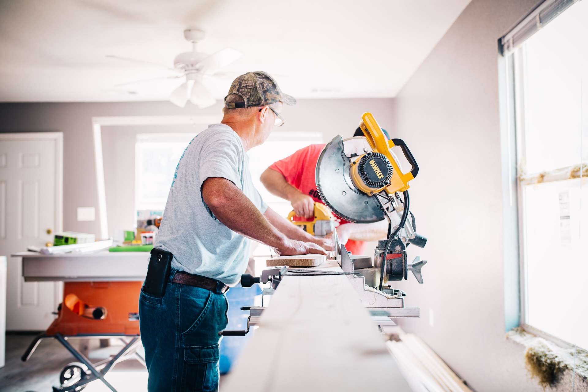 Someone using a saw in a house