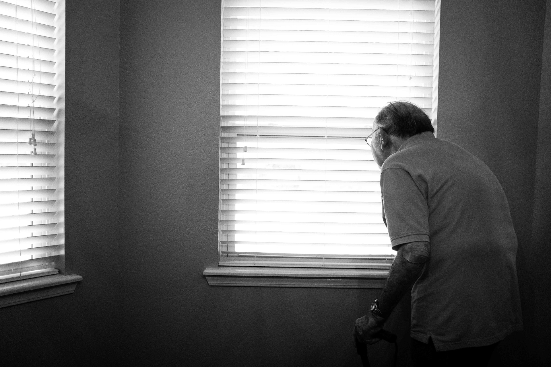 Old person looking out of a window