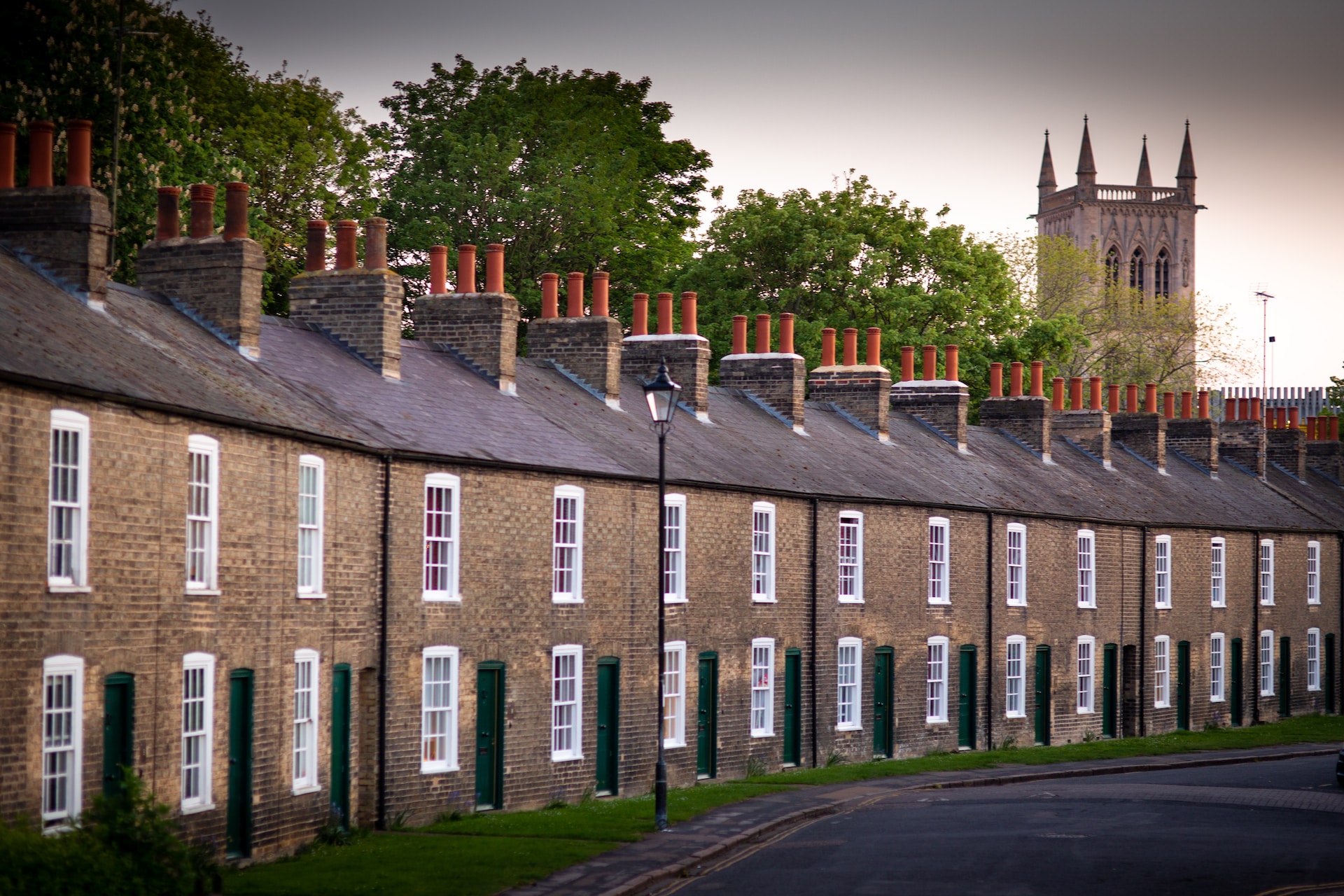 A row of houses with a church in the distance