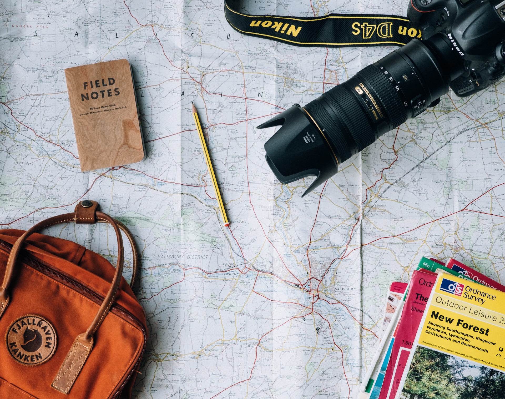 An assortment of travelling essentials on a map