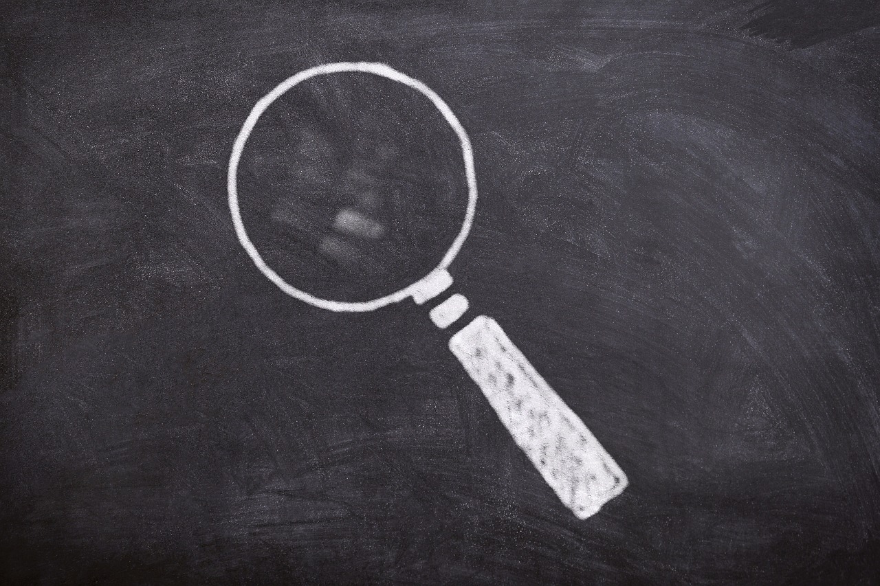 a magnifying glass drawn on a chalkboard