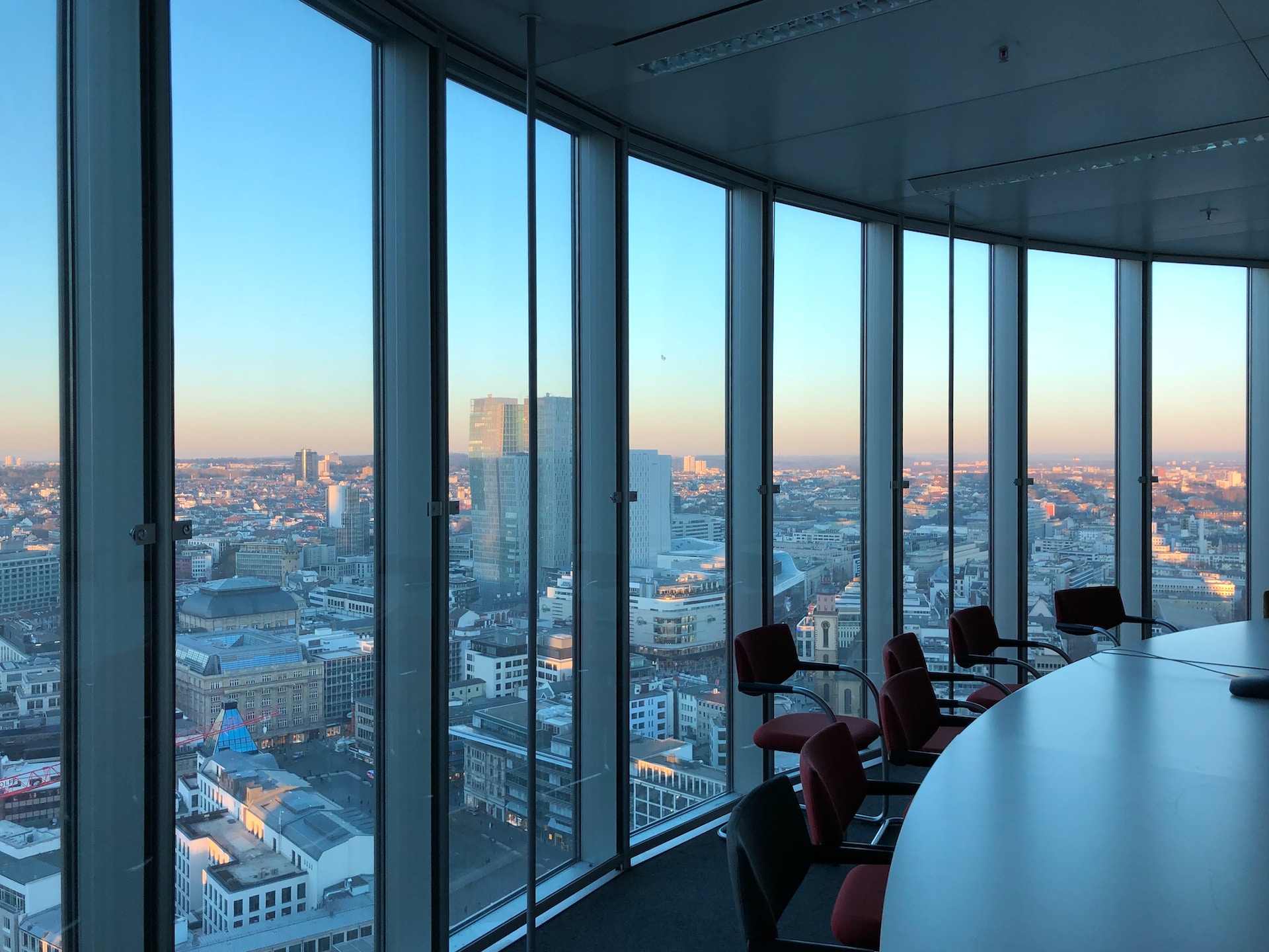 An empty boardroom with a city backdrop