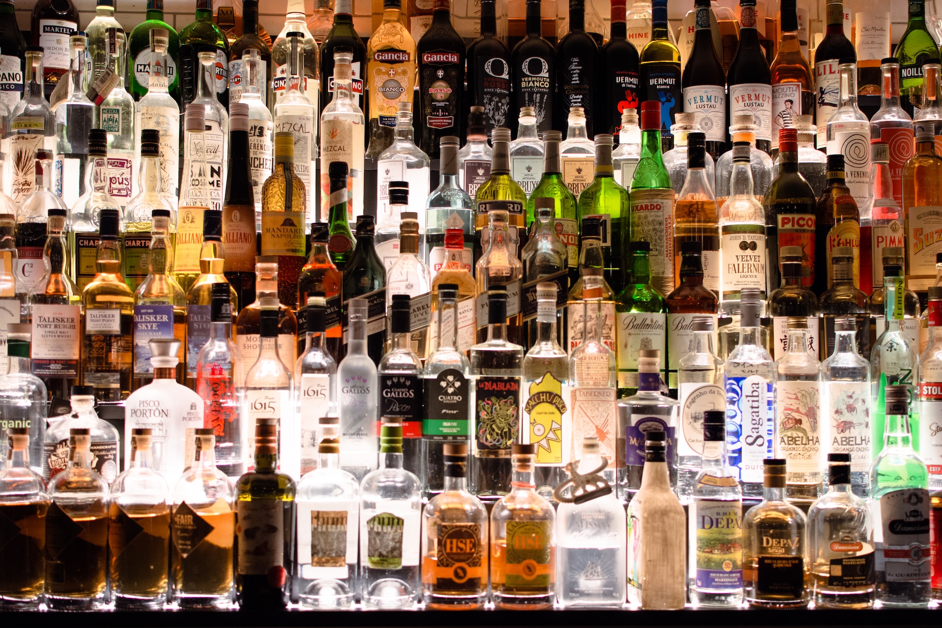 A bar well stocked with a collection of alcohol