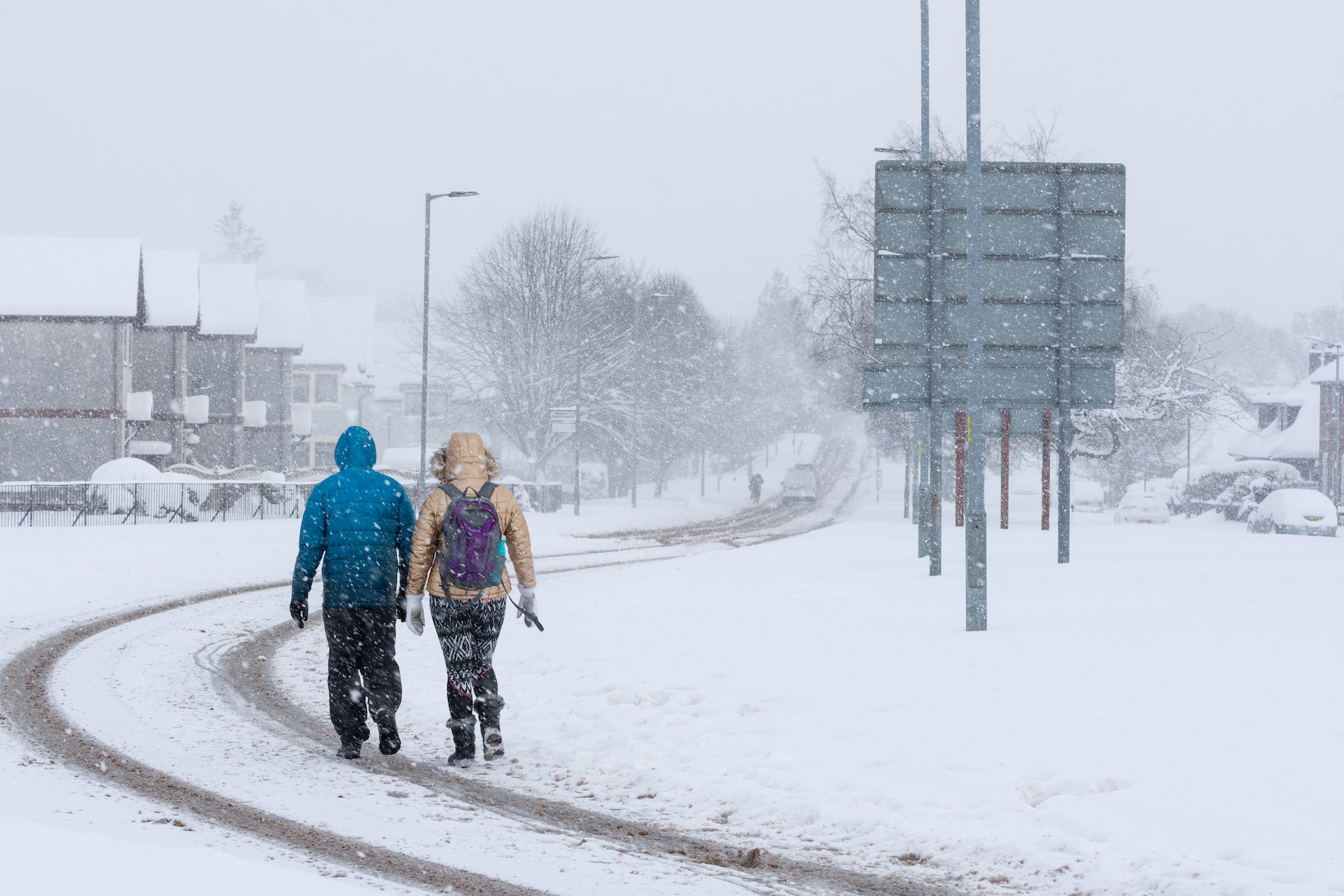 Two people walking in the snow