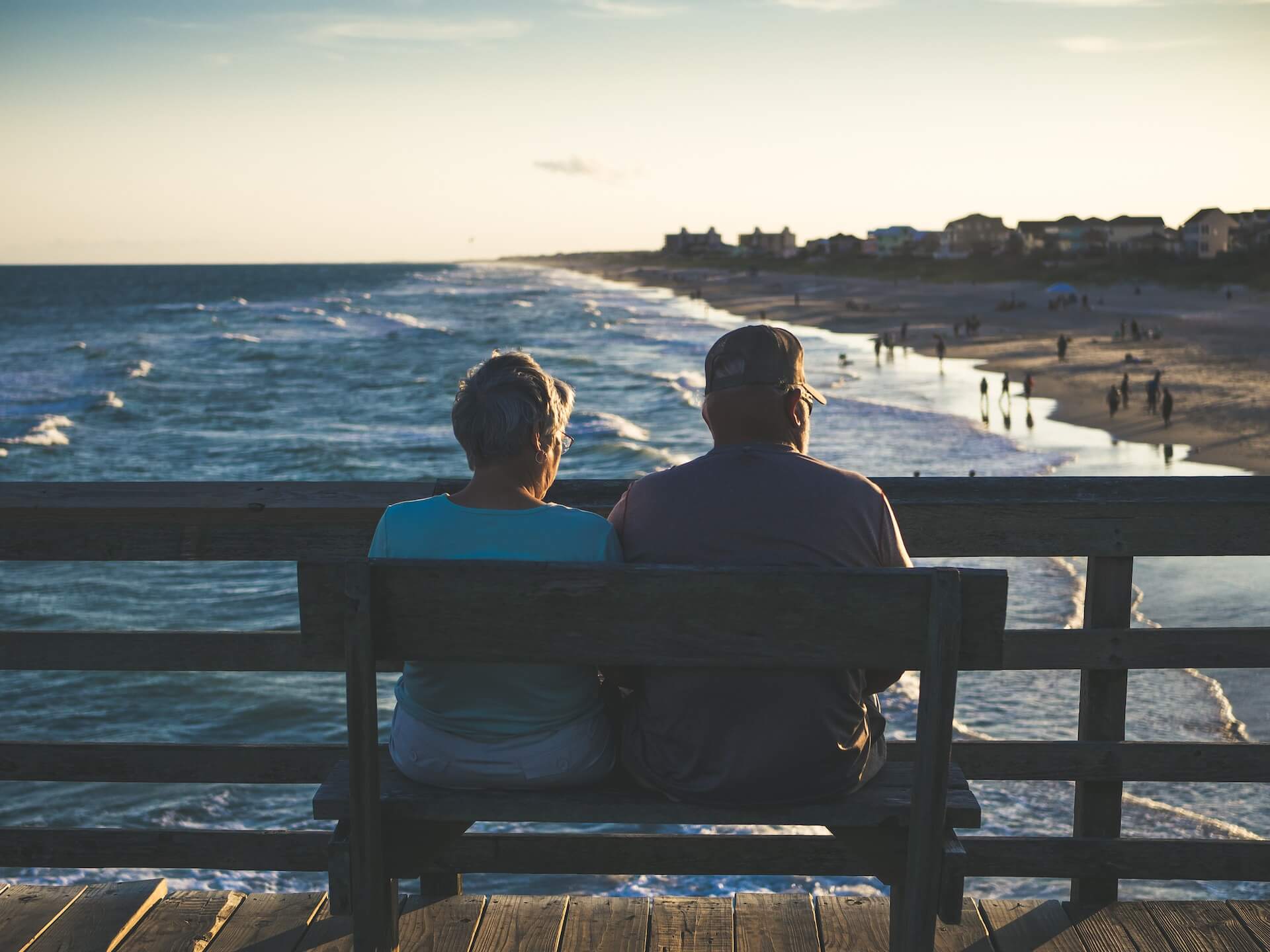 An elderly couple sat on a bench