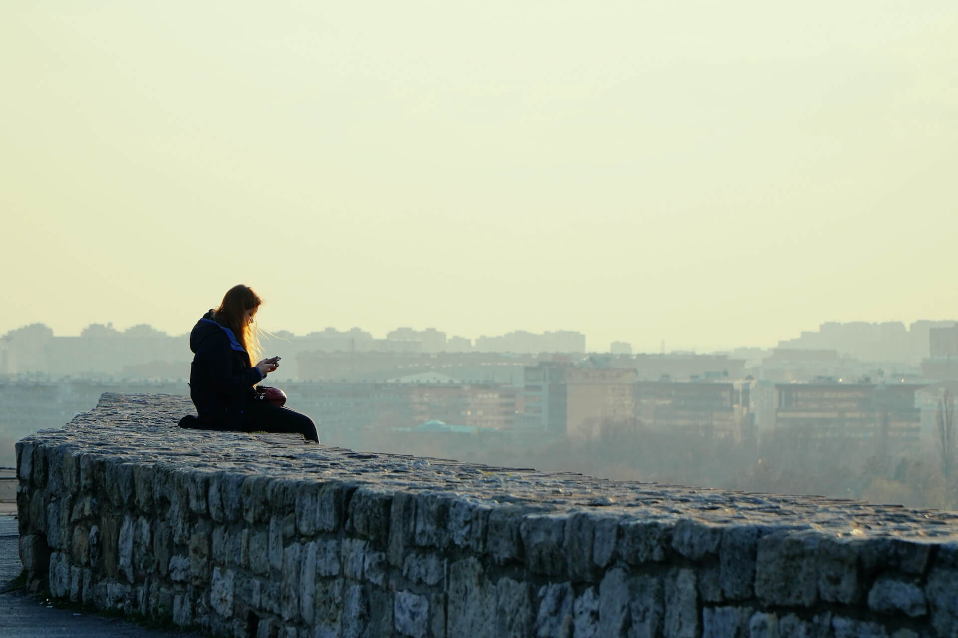 Someone sitting outside alone