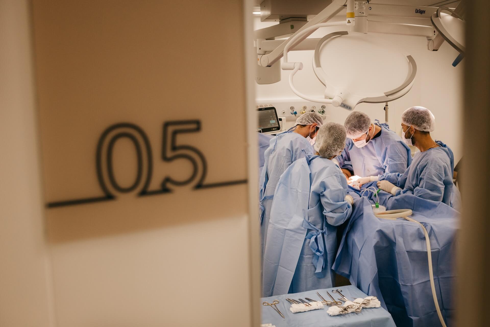 A group of surgeons in an operating theatre