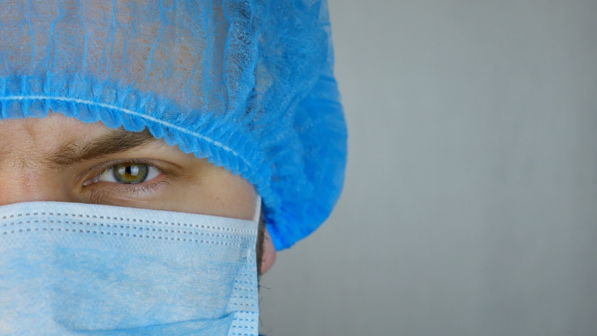 A doctor with a mask and hairnet