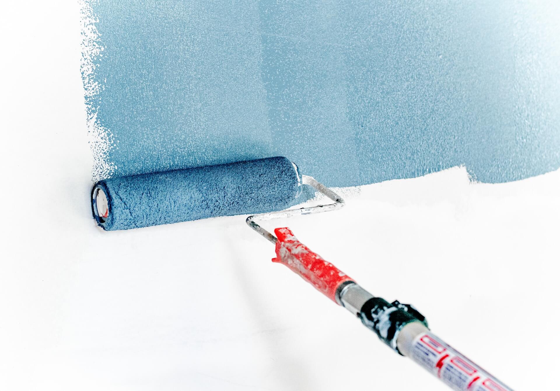 paint being applied to a wall with a roller