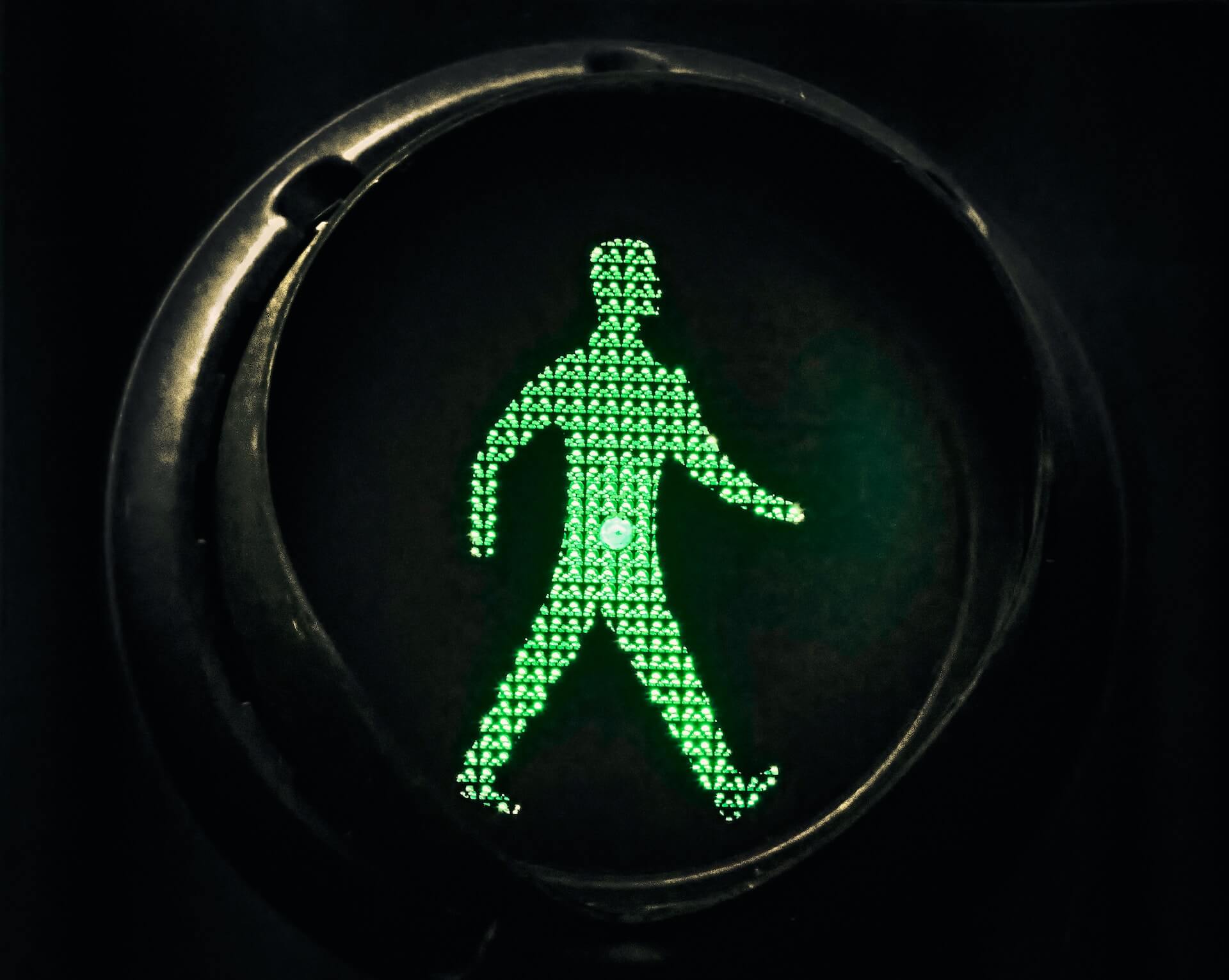 A signal indicating it is safe for a pedestrian to cross a road