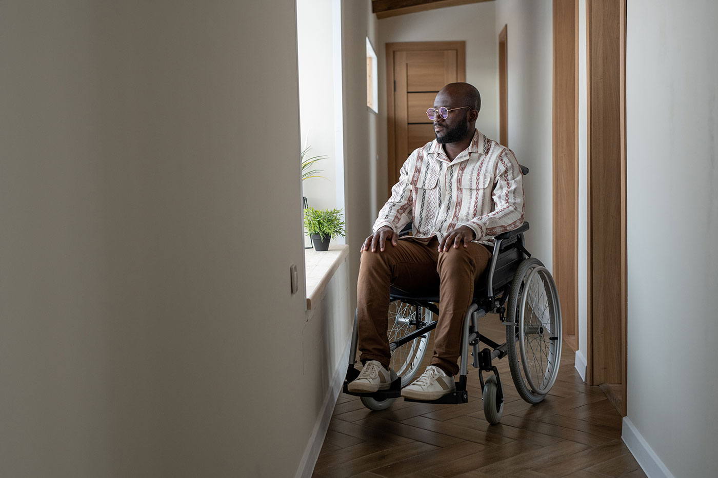 man in wheelchair in hallway