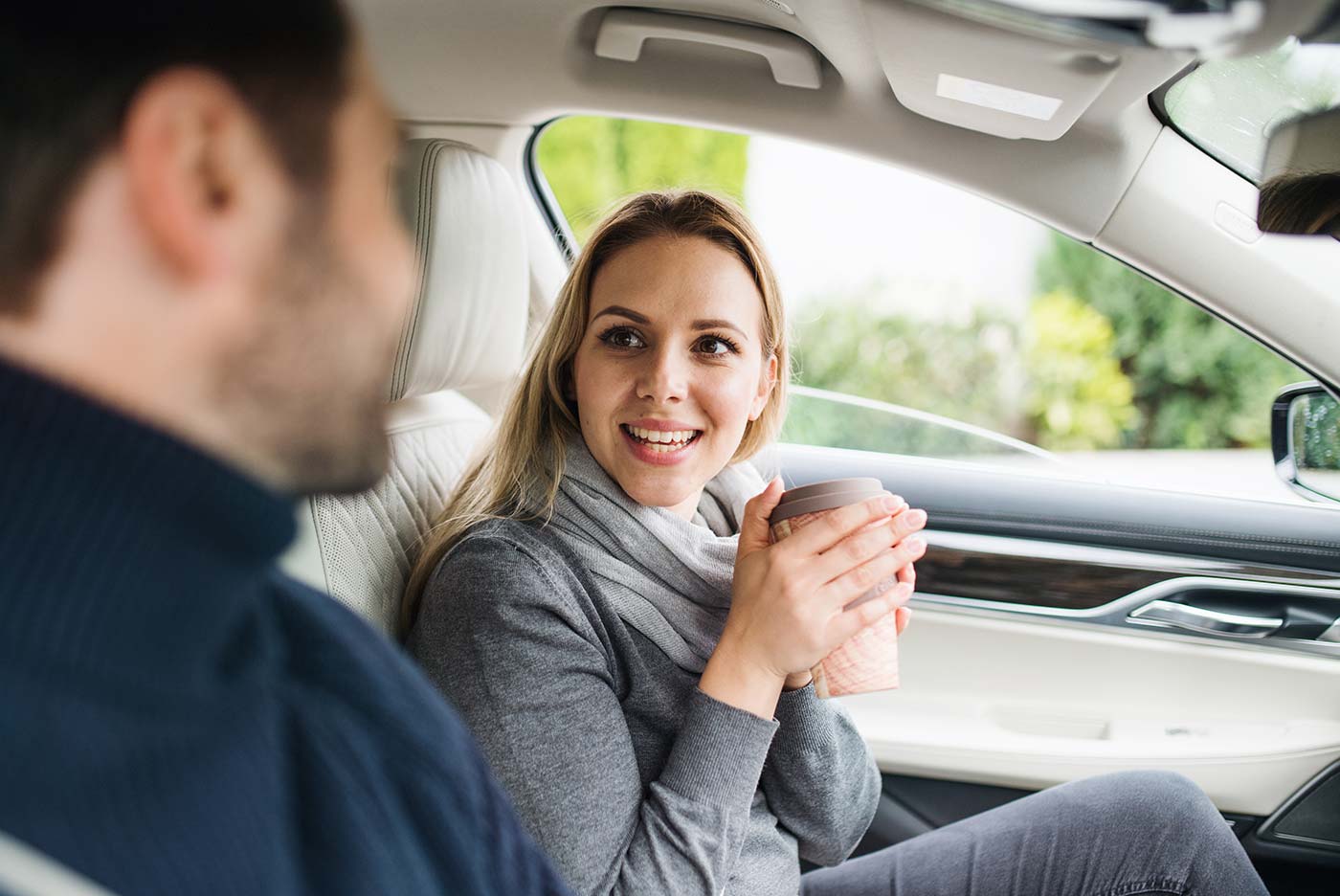 car passenger sitting with cup of coffee